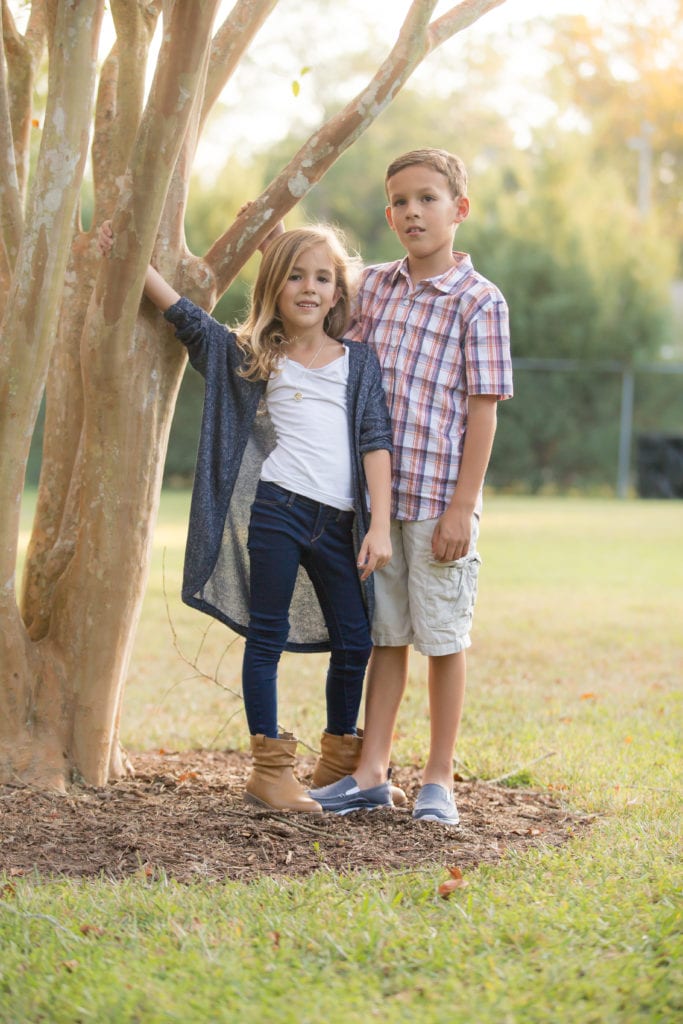 siblings posing for family photo in ocala