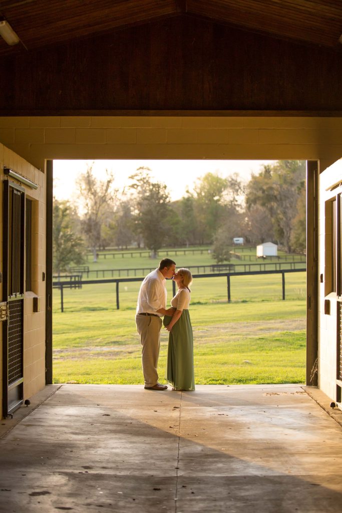 Pregnant couple kissing