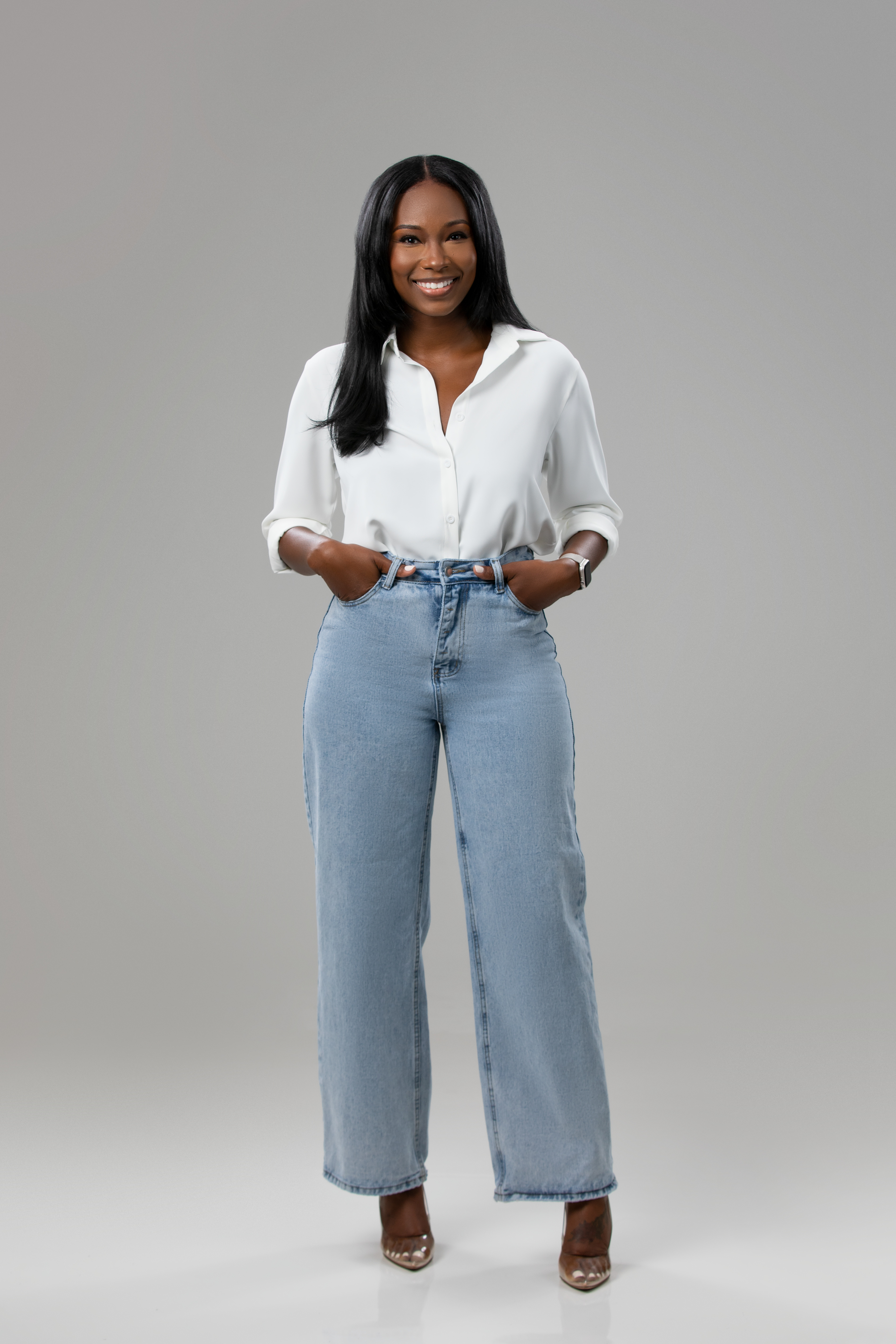 African American woman wearing trendy jeans and a white button down shirt