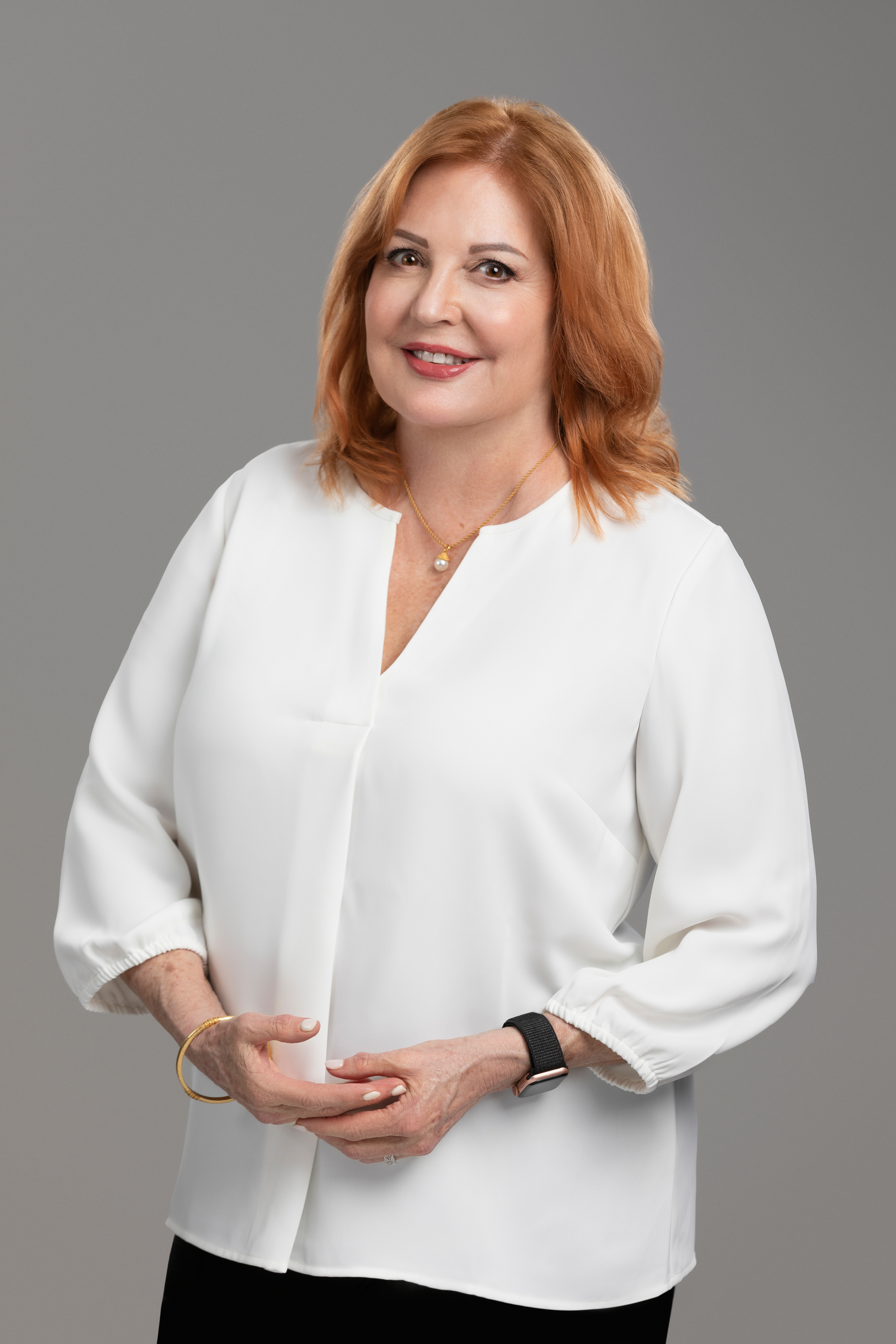 Red haired woman wearing white blouse