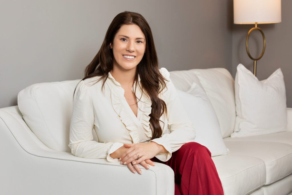 Young lady sitting on a white sofa